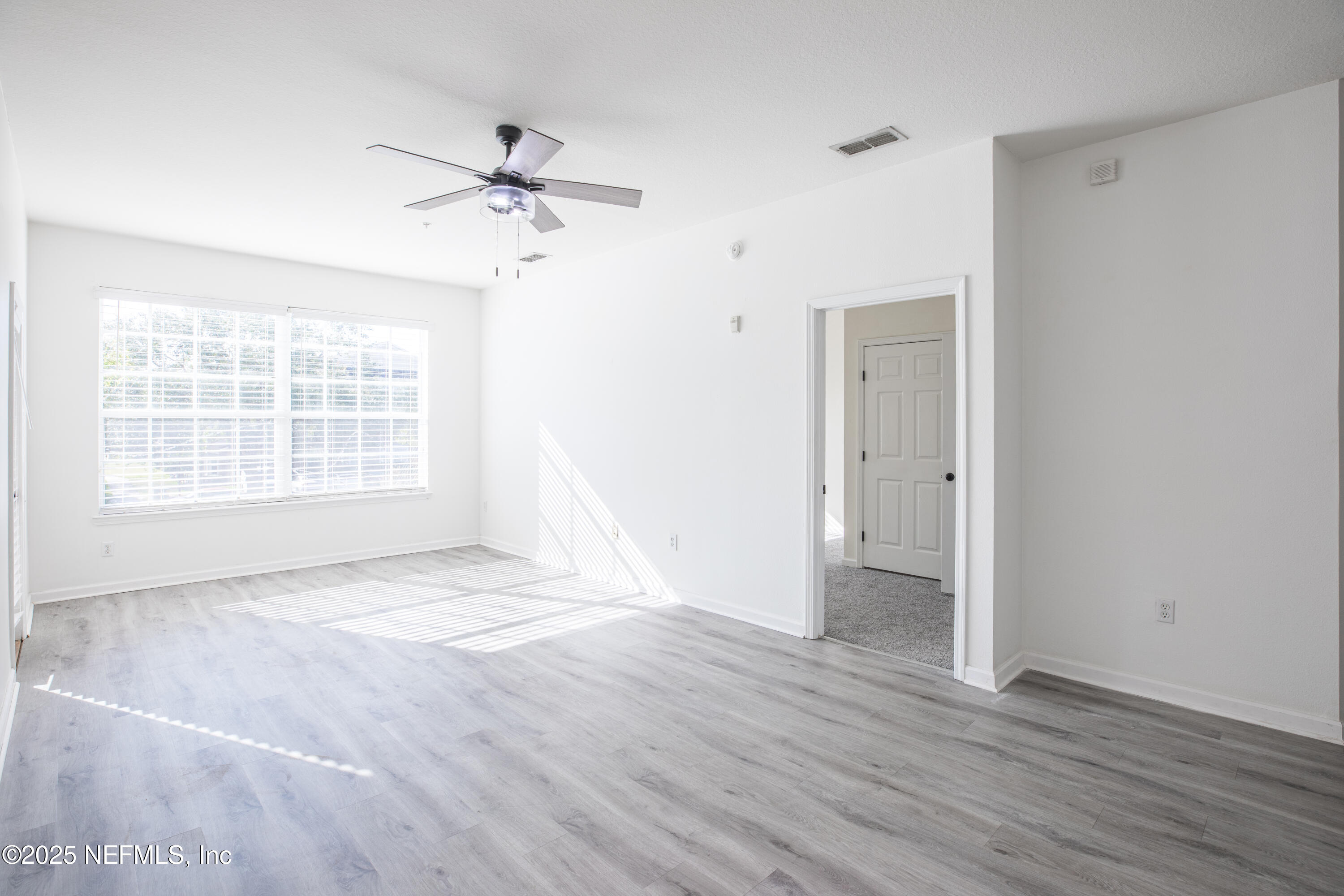 7990 Baymeadows Road, Unit 625 Jacksonville, FL 32256 - Photo 6 of 25 wooden floor in an empty room with a window