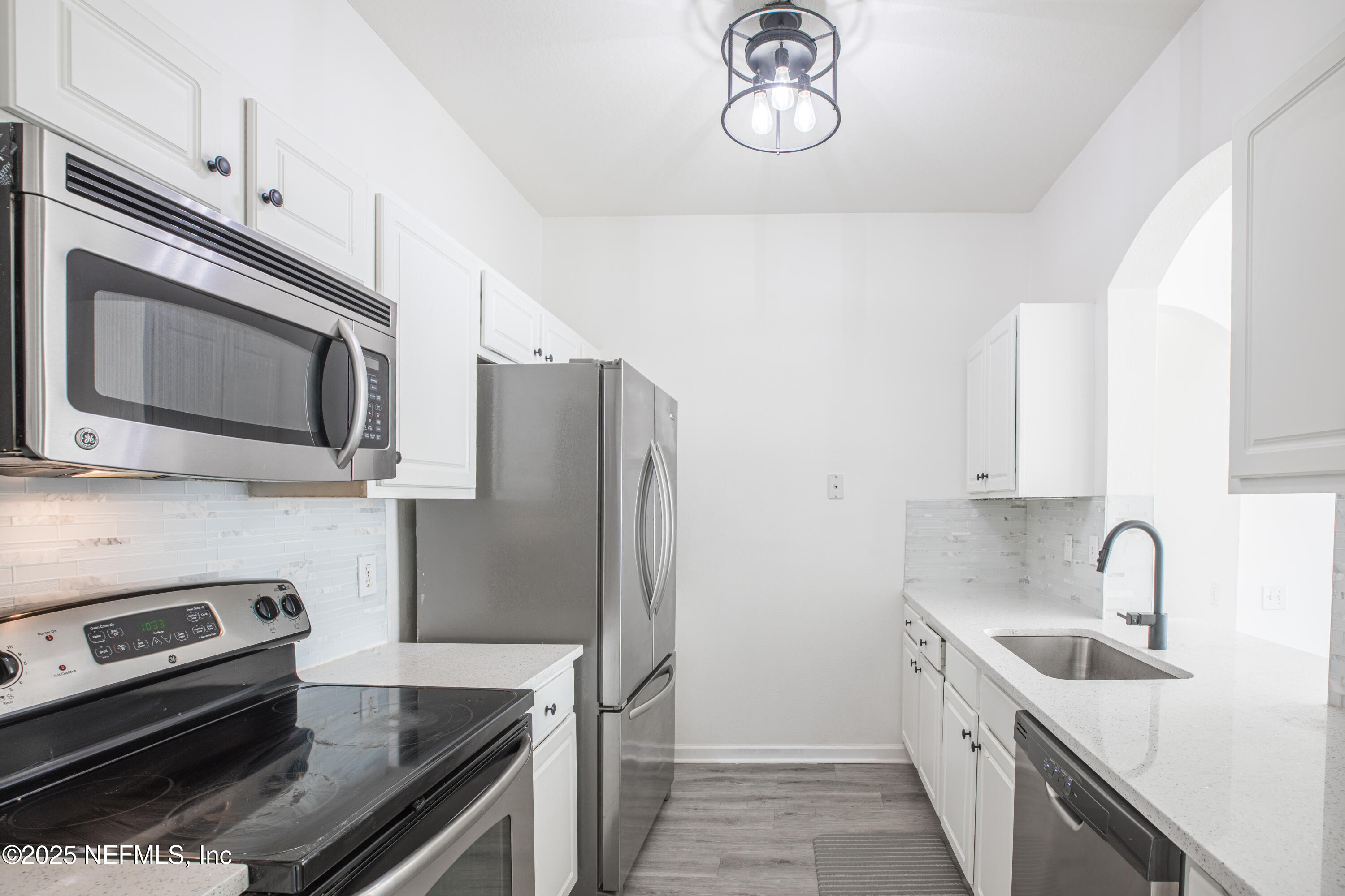 7990 Baymeadows Road, Unit 625 Jacksonville, FL 32256 - Photo 10 of 25 a kitchen with stainless steel appliances a sink a stove a microwave and cabinets