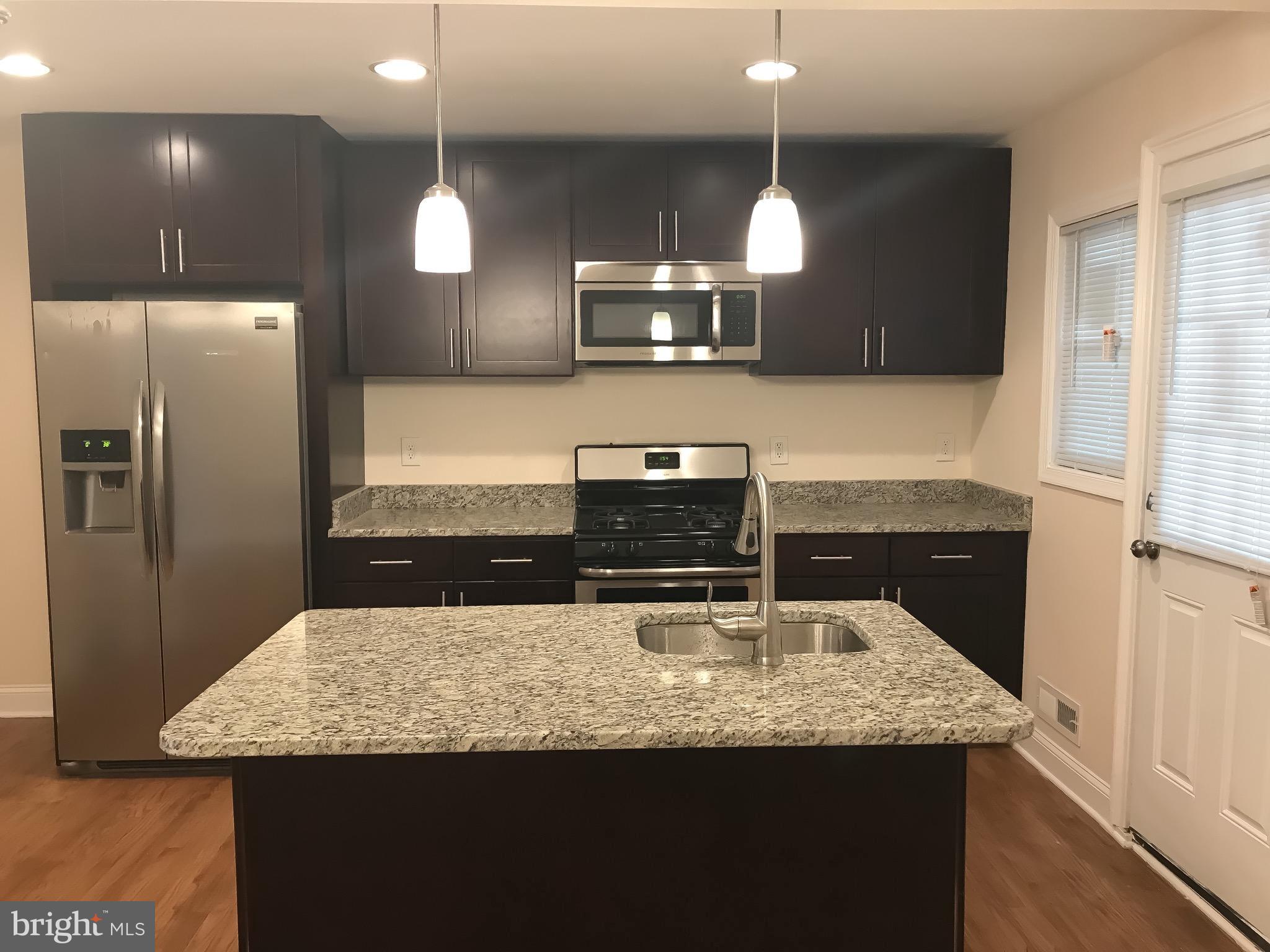 1713 Stokesley Road Baltimore, MD 21222 - Photo 4 of 15 a kitchen with stainless steel appliances granite countertop a sink a refrigerator and a stove