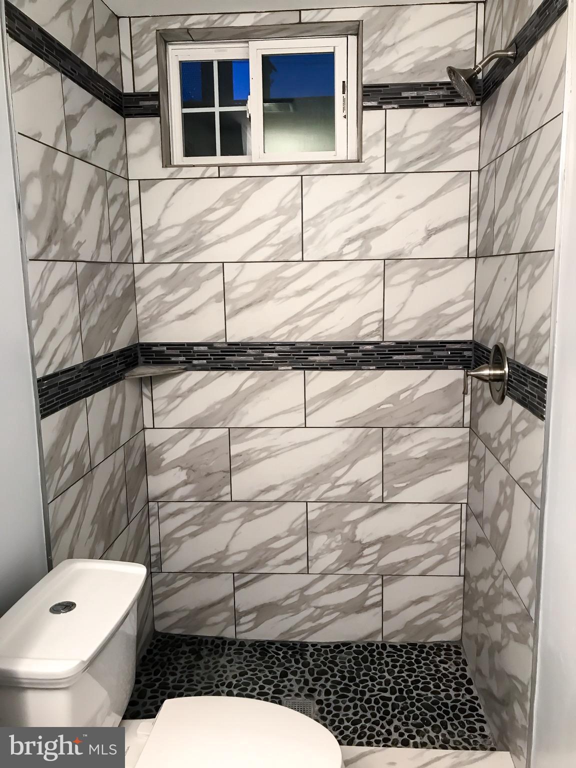 1713 Stokesley Road Baltimore, MD 21222 - Photo 9 of 15 a bathroom with a toilet and a shower