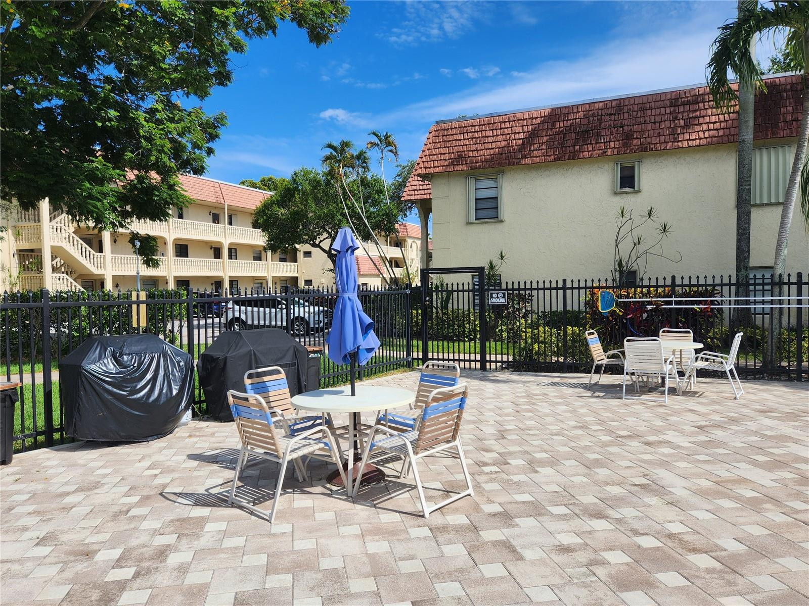 138 South Cypress Road, Unit 217 Pompano Beach, FL 33060 - Photo 11 of 21 a view of a chairs and tables in the patio in front of a house