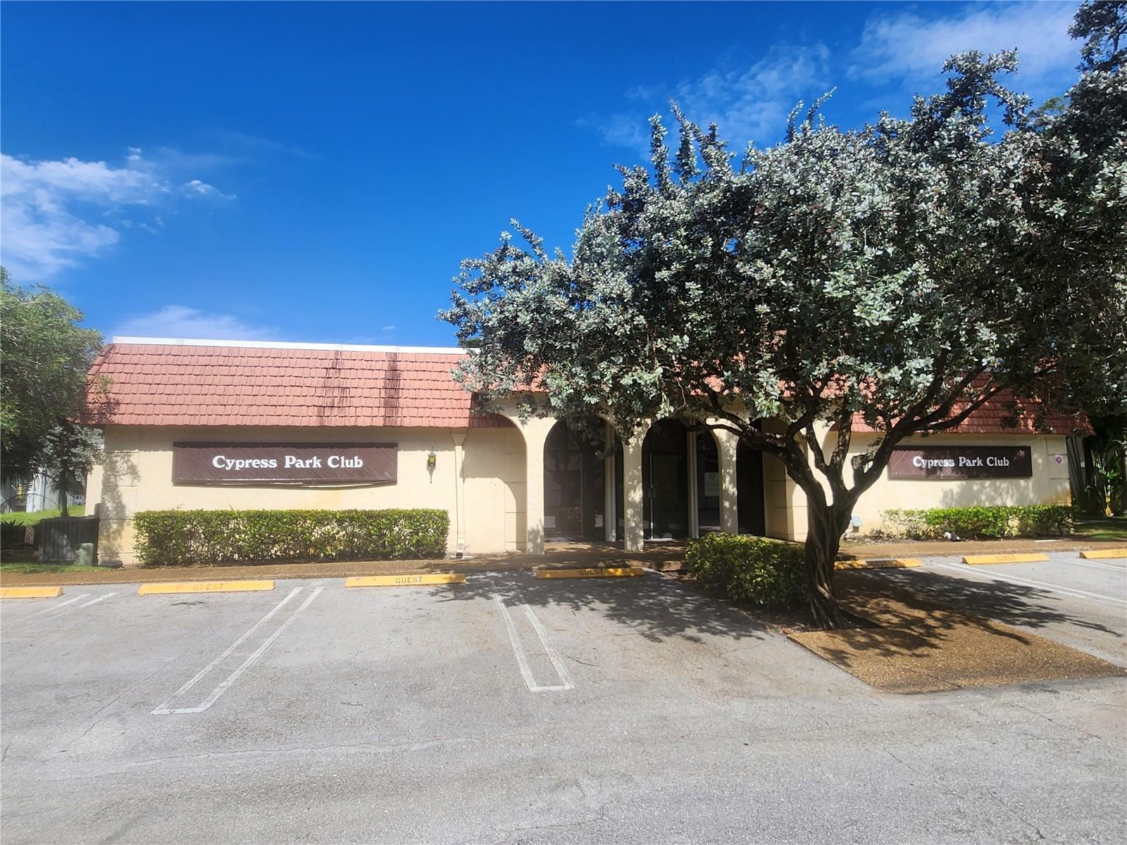 138 South Cypress Road, Unit 217 Pompano Beach, FL 33060 - Photo 12 of 21 a view of a house with a yard and large tree