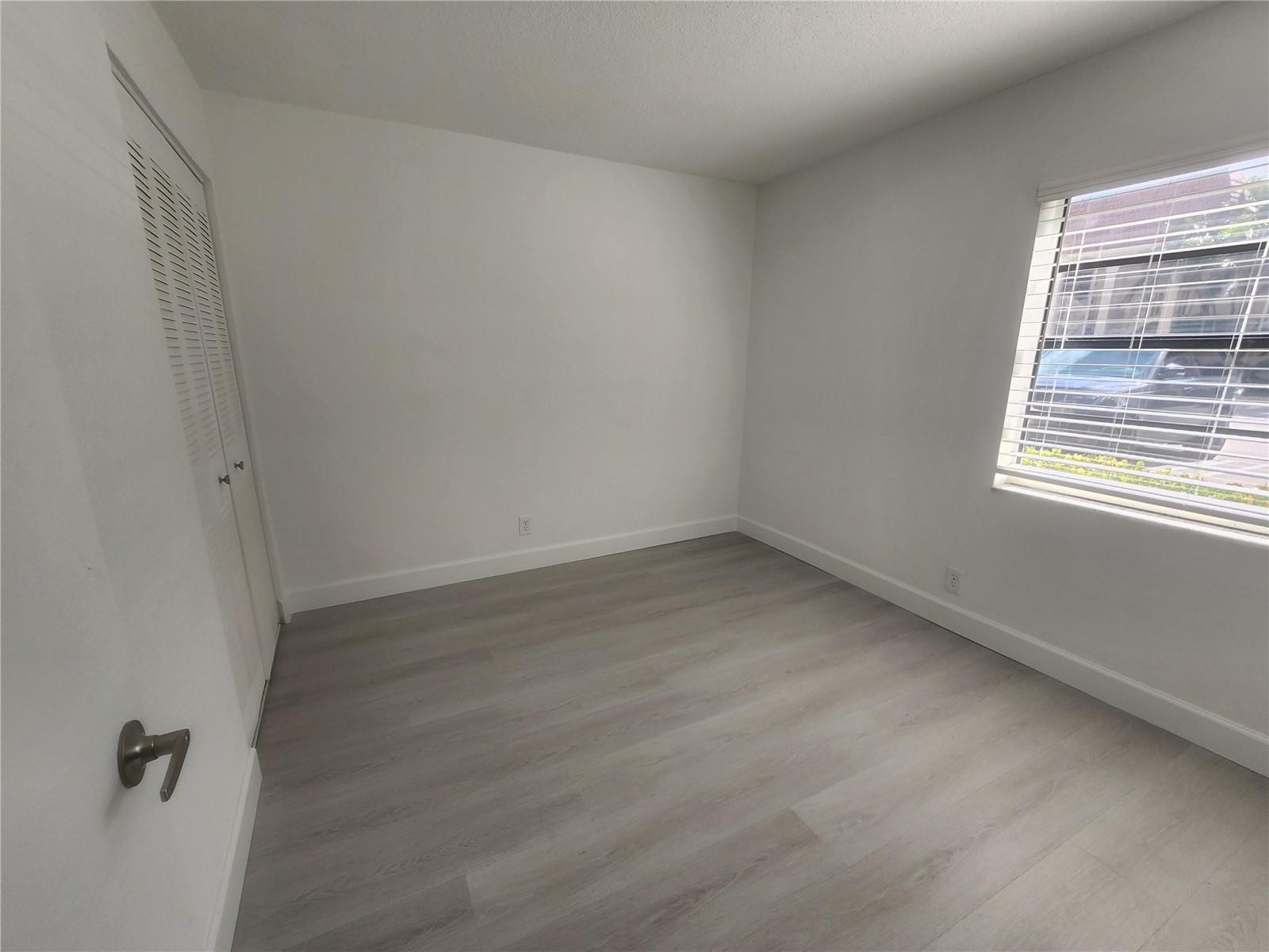138 South Cypress Road, Unit 217 Pompano Beach, FL 33060 - Photo 17 of 21 an empty room with a window