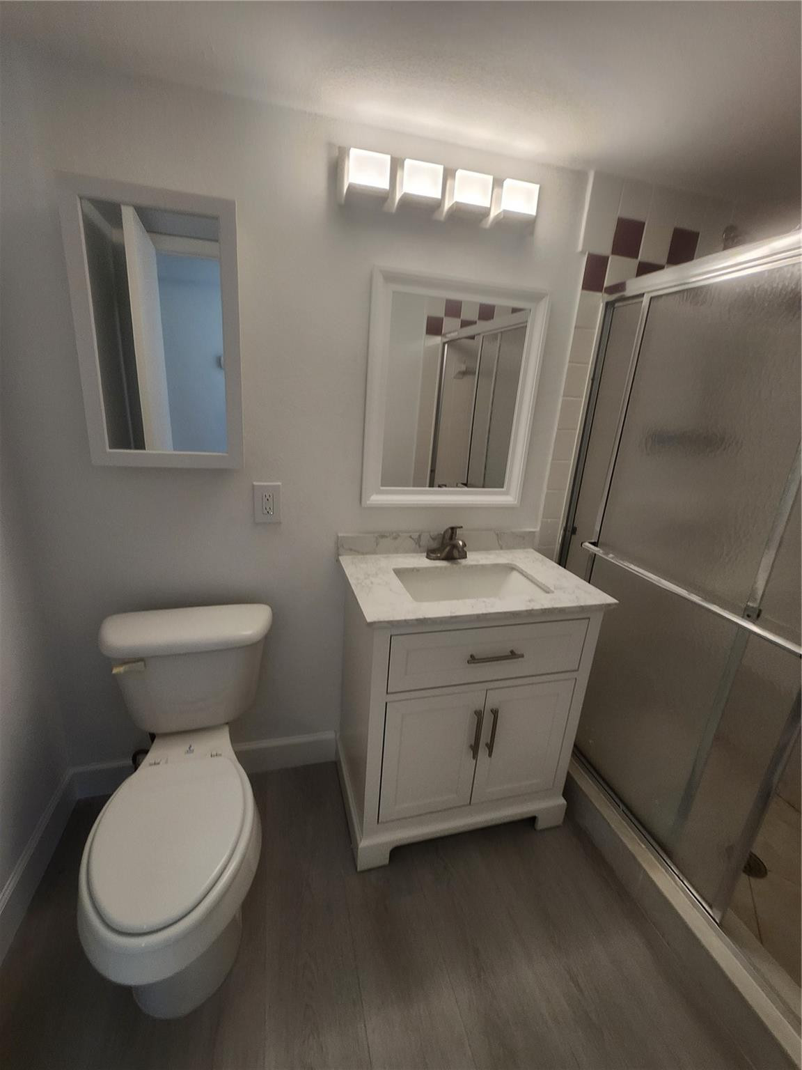 138 South Cypress Road, Unit 217 Pompano Beach, FL 33060 - Photo 18 of 21 a bathroom with a sink toilet and mirror