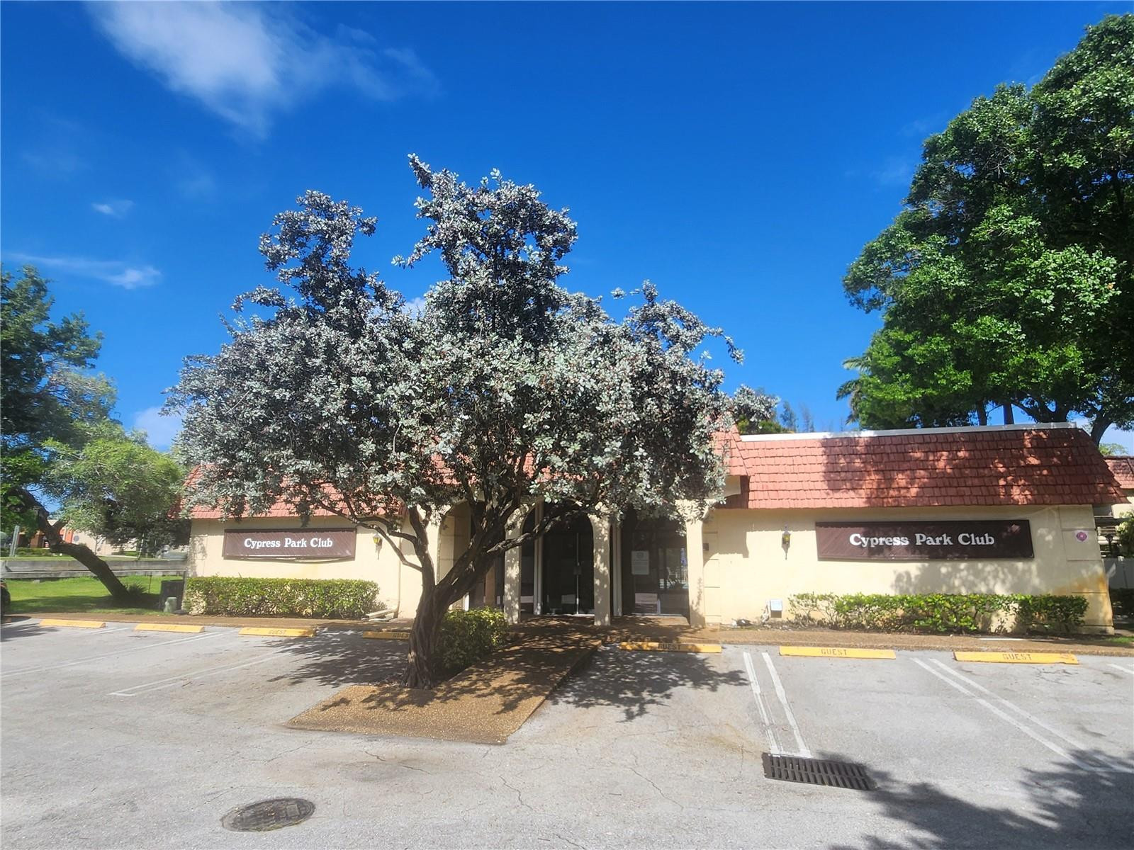 138 South Cypress Road, Unit 217 Pompano Beach, FL 33060 - Photo 20 of 21 a front view of a house with a yard and garage