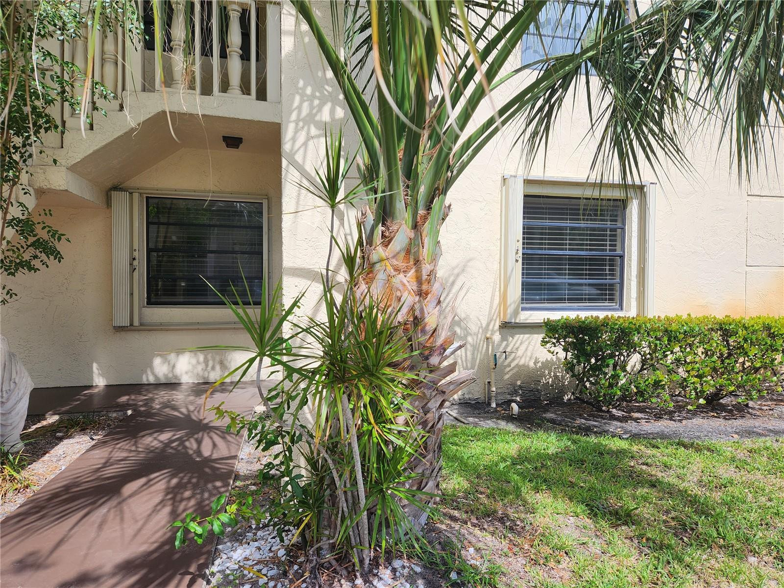 138 South Cypress Road, Unit 217 Pompano Beach, FL 33060 - Photo 7 of 21 a front view of a house with a yard
