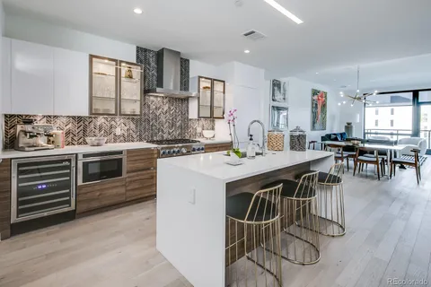 a kitchen with a table chairs stove and cabinets