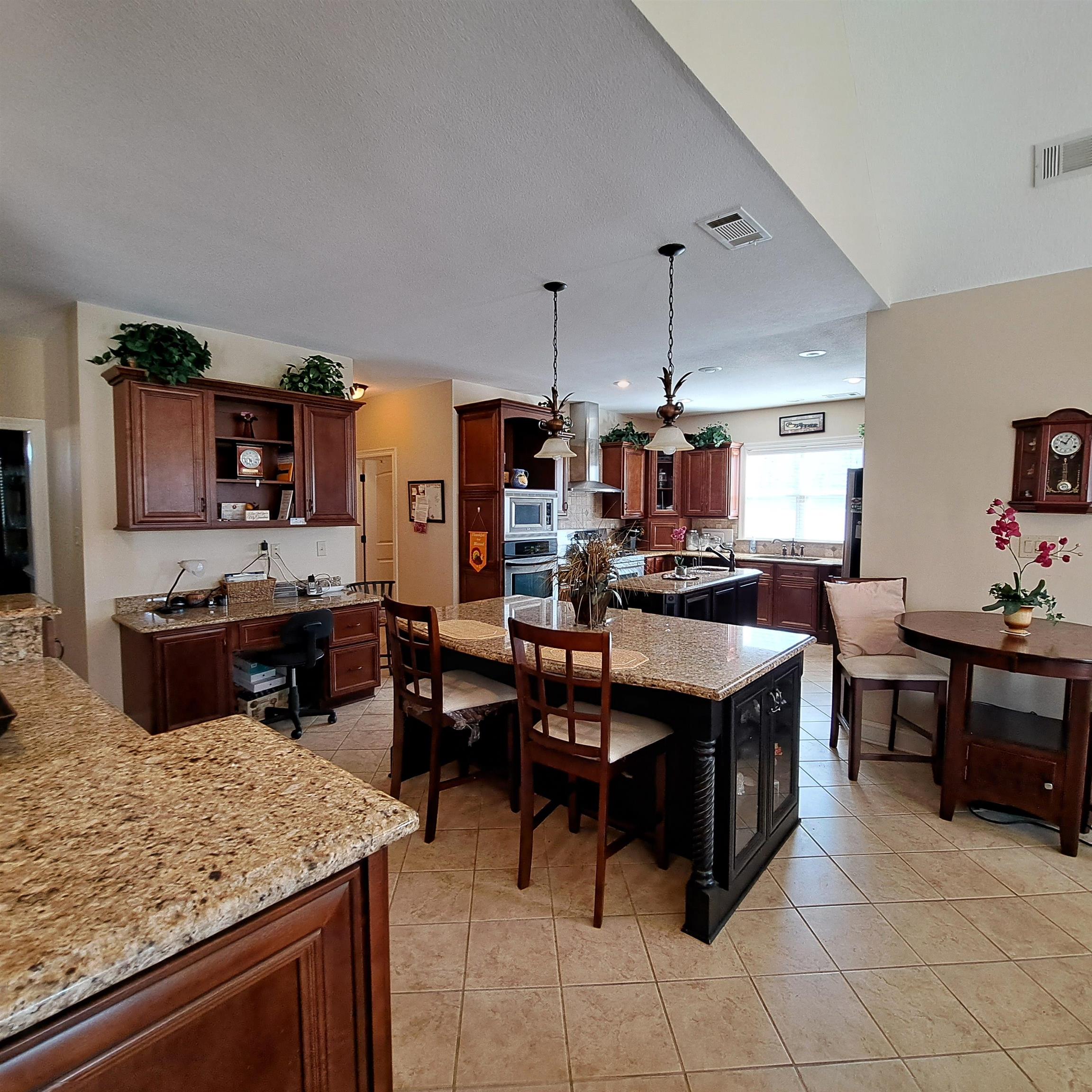 5516 Hayes Road Arlington, TN 38002 - Photo 11 of 38 Stunning arches, colums, breakfast bar with custom cabinets, with tons of storage drawers and shelves for you whatnots.