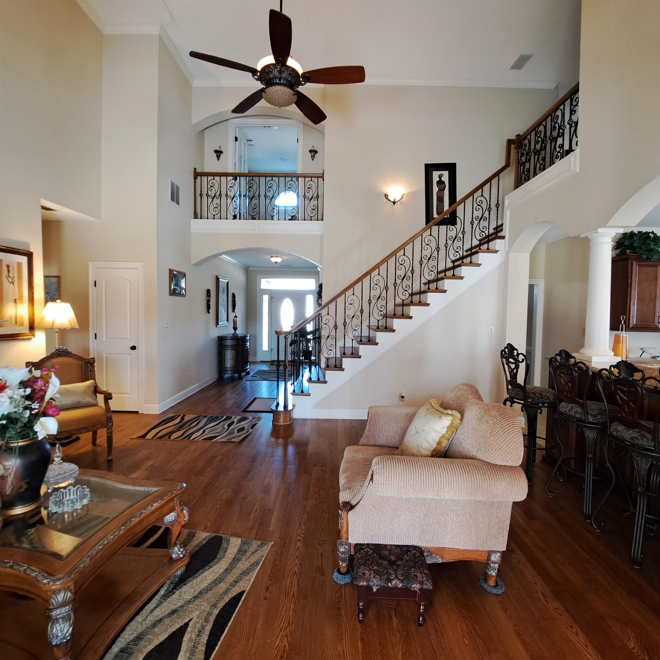 5516 Hayes Road Arlington, TN 38002 - Photo 8 of 38 Hardwood flooring with columns at the formal dining room entry. Stunning open area with staircase, living area with fireplace, keeping room and kitchen. All open.
