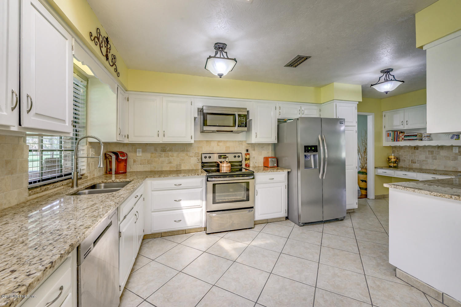 17525 Eagle Bend Boulevard Jacksonville, FL 32226 - Photo 13 of 49 a kitchen with a refrigerator sink and stove