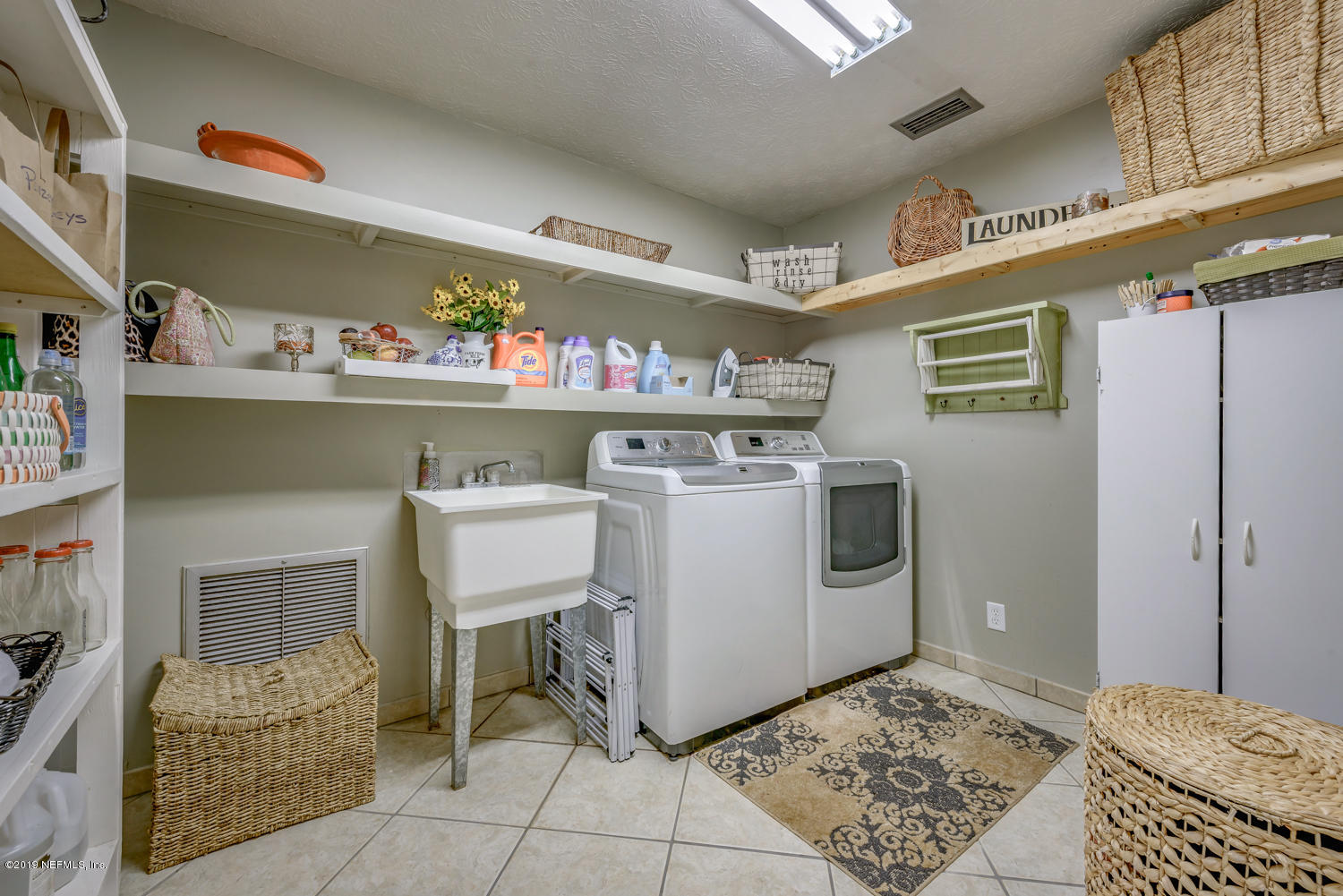 17525 Eagle Bend Boulevard Jacksonville, FL 32226 - Photo 16 of 49 a utility room with stainless steel appliances kitchen island granite countertop furniture and a refrigerator