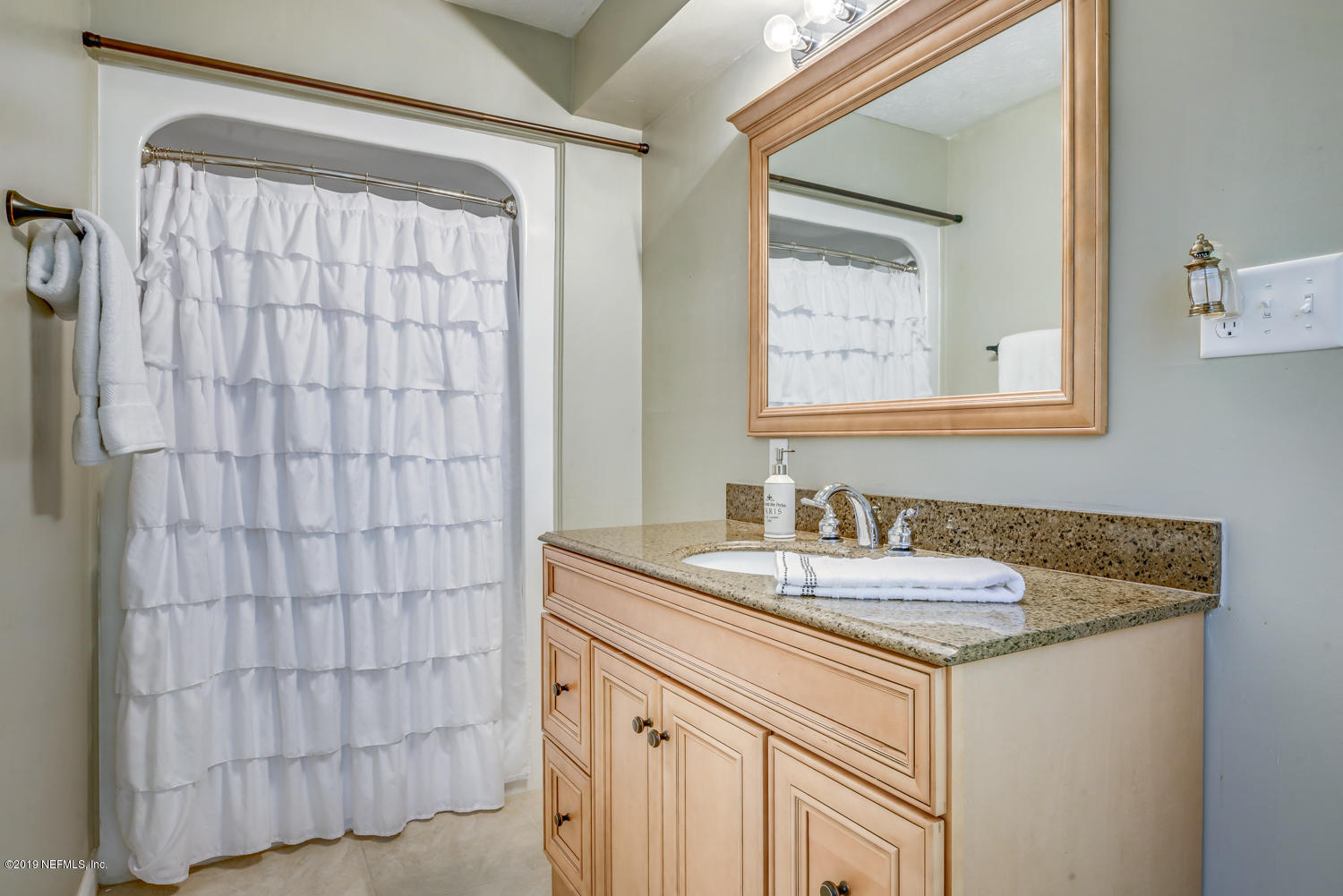 17525 Eagle Bend Boulevard Jacksonville, FL 32226 - Photo 26 of 49 a bathroom with a granite countertop sink and a mirror