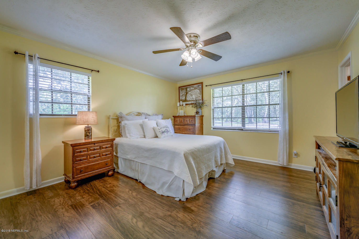 17525 Eagle Bend Boulevard Jacksonville, FL 32226 - Photo 27 of 49 a bedroom with a bed and a chandelier