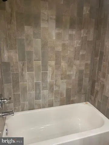 a kitchen with stainless steel appliances white cabinets and a refrigerator