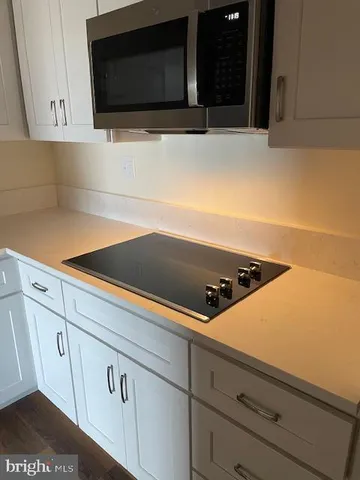 a view of room with window and wooden floor