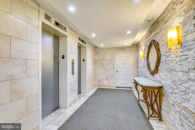 a kitchen with stainless steel appliances kitchen island granite countertop a stove and a white cabinets