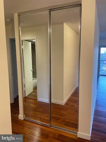 a view of a room with wooden floor and chandelier
