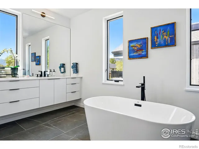 a view of a living room with a chair and a potted plant