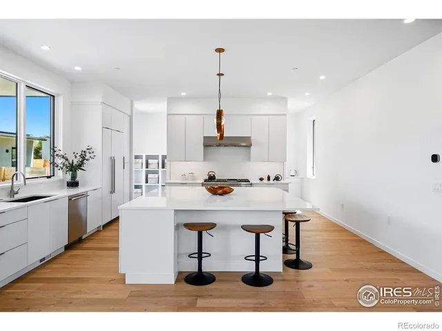 a kitchen with a stove cabinets and a window