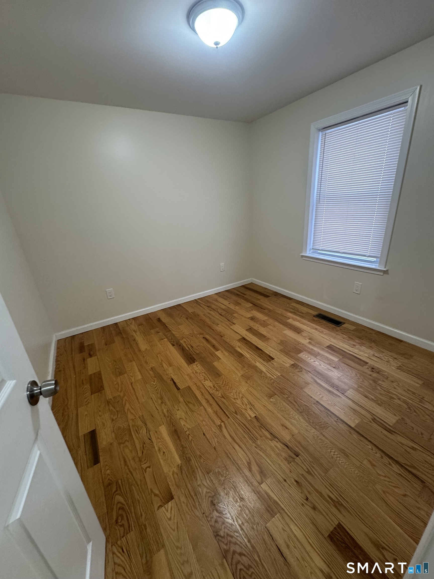 695 Shelton Street Bridgeport, CT 06608 - Photo 26 of 36 a view of a room with wooden floor and window