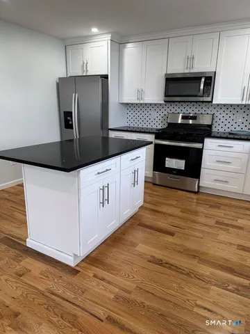 a kitchen with stainless steel appliances a refrigerator stove and sink