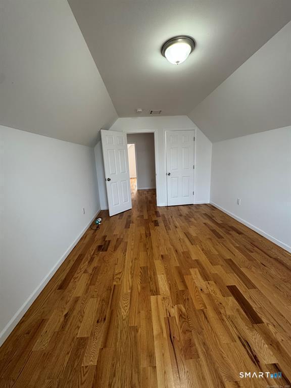 695 Shelton Street Bridgeport, CT 06608 - Photo 10 of 36 a view of a room with a wooden floor