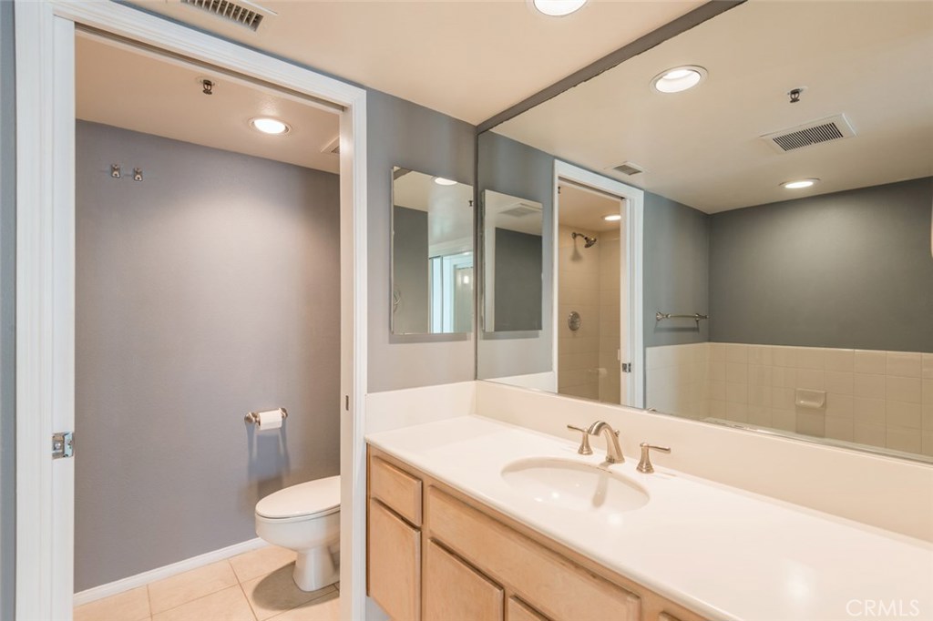 200 Pacific Coast Highway, Unit 314 Huntington Beach, CA 92648 - Photo 12 of 26 a bathroom with a sink a toilet and shower