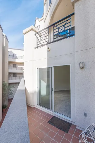 a view of a house with a door and wooden bench