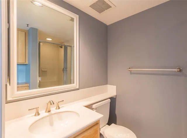 a bathroom with a sink toilet and mirror