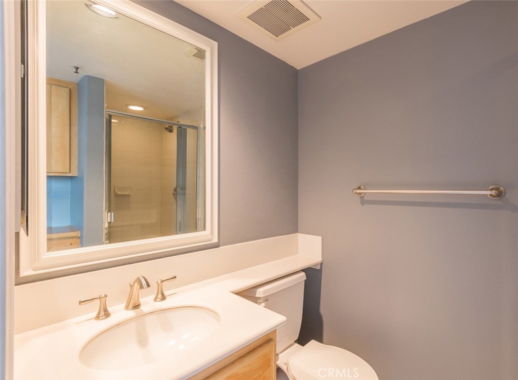 200 Pacific Coast Highway, Unit 314 Huntington Beach, CA 92648 - Photo 20 of 26 a bathroom with a sink toilet and mirror