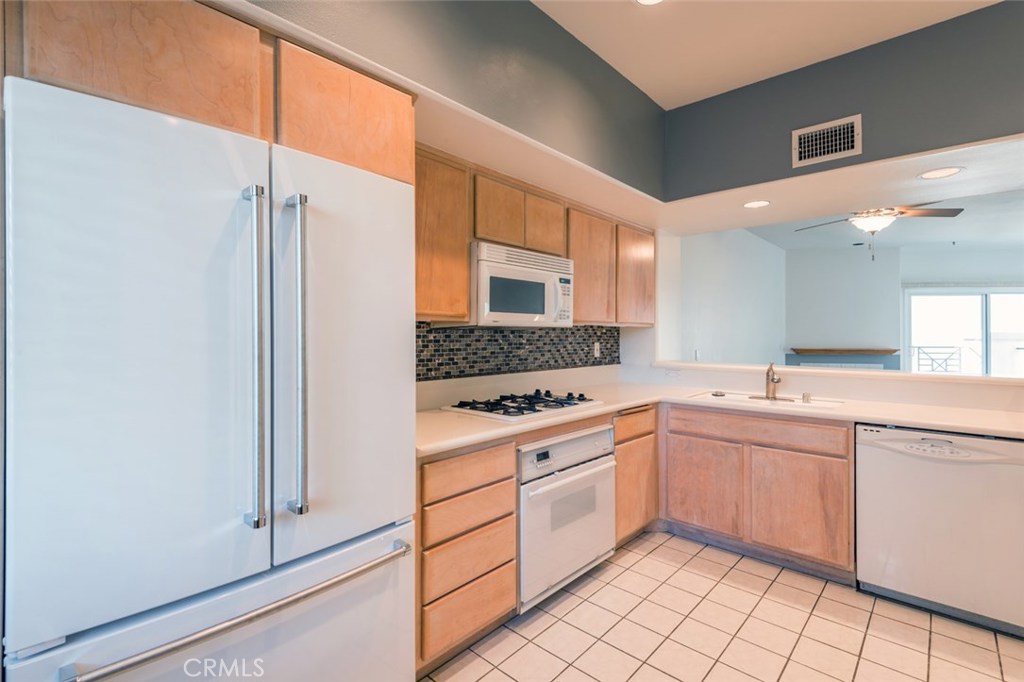 200 Pacific Coast Highway, Unit 314 Huntington Beach, CA 92648 - Photo 2 of 26 a kitchen with a sink stove and cabinets