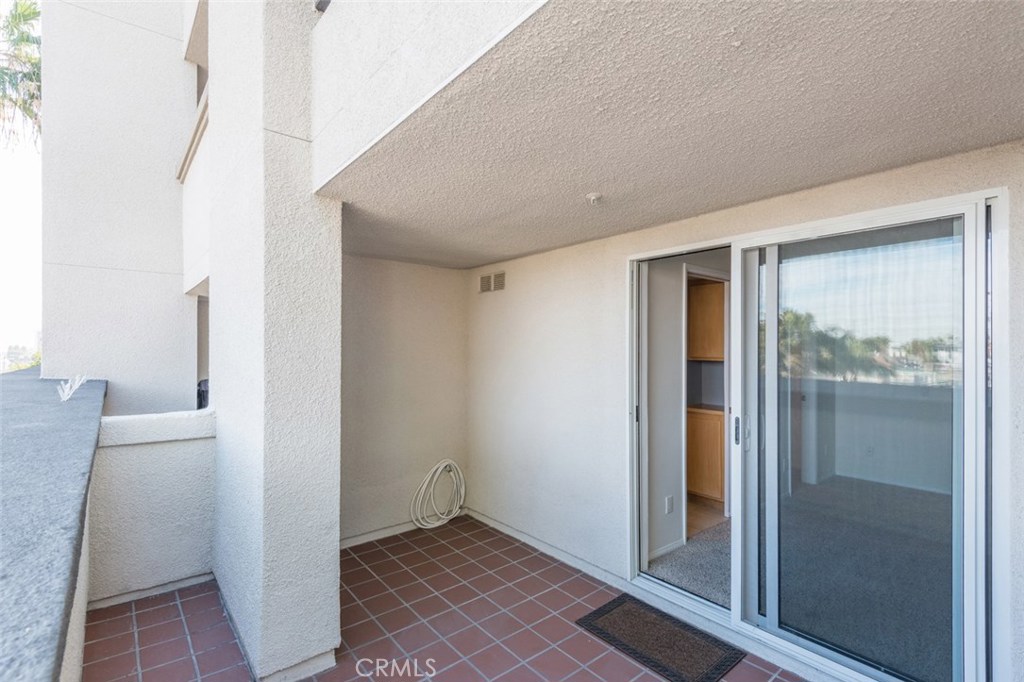 200 Pacific Coast Highway, Unit 314 Huntington Beach, CA 92648 - Photo 21 of 26 a view of a hallway with a glass door and a white door