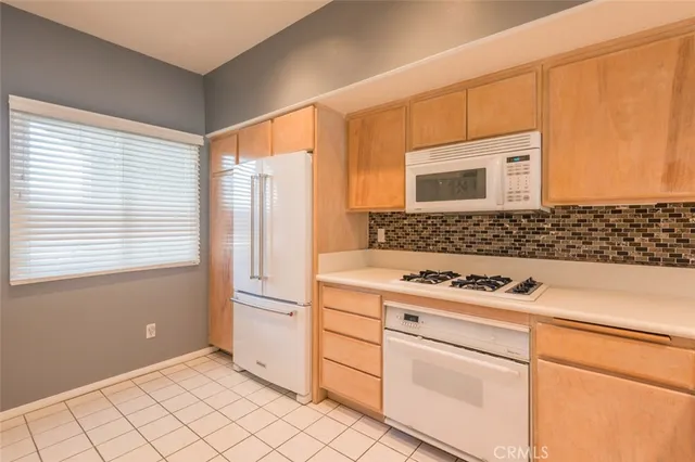 a kitchen with cabinets and appliances