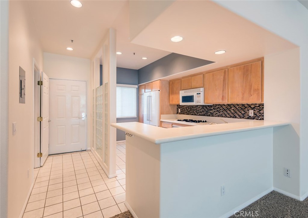 200 Pacific Coast Highway, Unit 314 Huntington Beach, CA 92648 - Photo 4 of 26 a kitchen with stainless steel appliances granite countertop a refrigerator and a stove