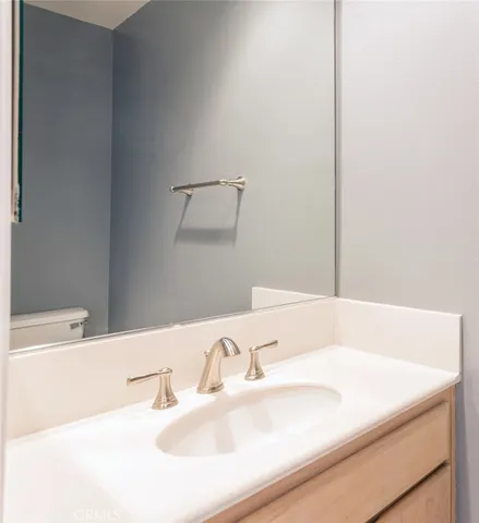 a bathroom with a sink and a large mirror