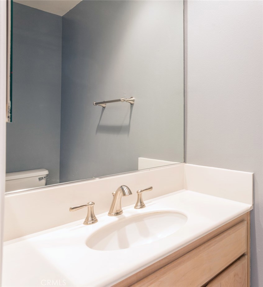 200 Pacific Coast Highway, Unit 314 Huntington Beach, CA 92648 - Photo 7 of 26 a bathroom with a sink and a large mirror