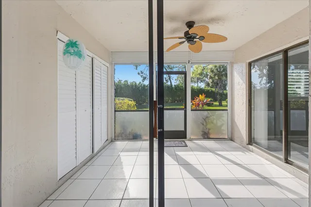 a living room with a large window and a chandelier