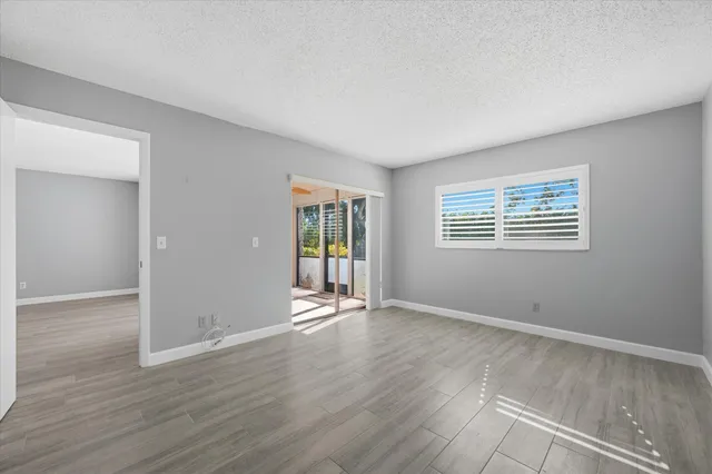 an empty room with wooden floor and door