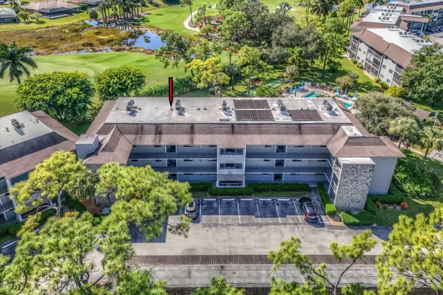 an aerial view of a house with a yard and lake view