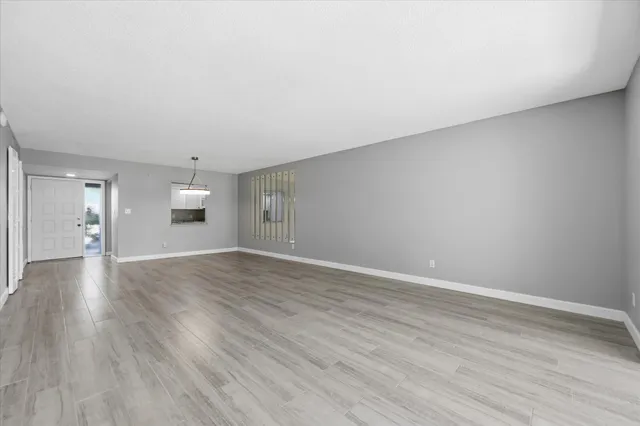 a view of wooden floor and a chandelier in a room