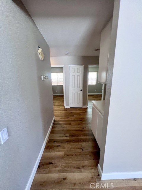 39879 Osprey Road Murrieta, CA 92562 - Photo 16 of 38 a view of a hallway with wooden floor and staircase