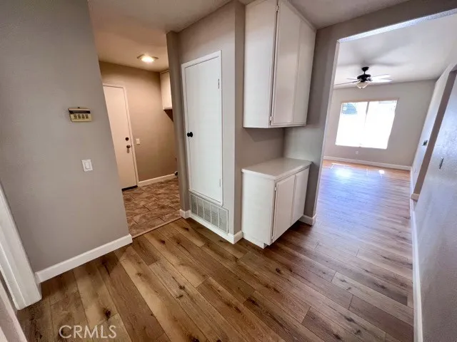 a view of a hallway with wooden floor and staircase