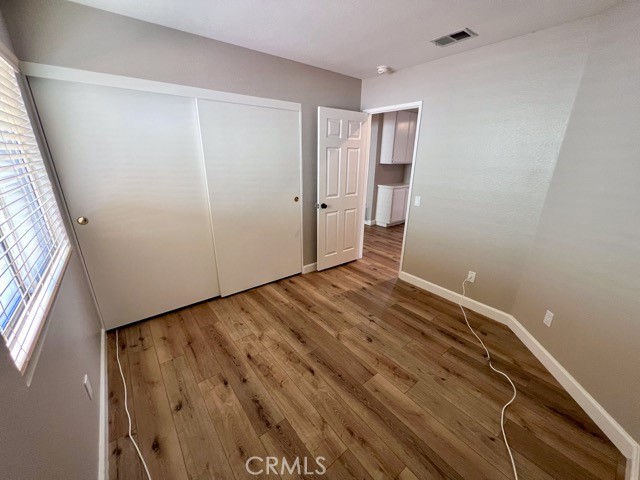 39879 Osprey Road Murrieta, CA 92562 - Photo 22 of 38 a view of empty room with wooden floor and fan
