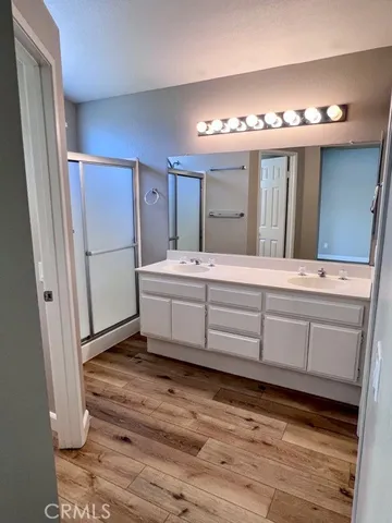 a bathroom with a sink a toilet a shower and a mirror