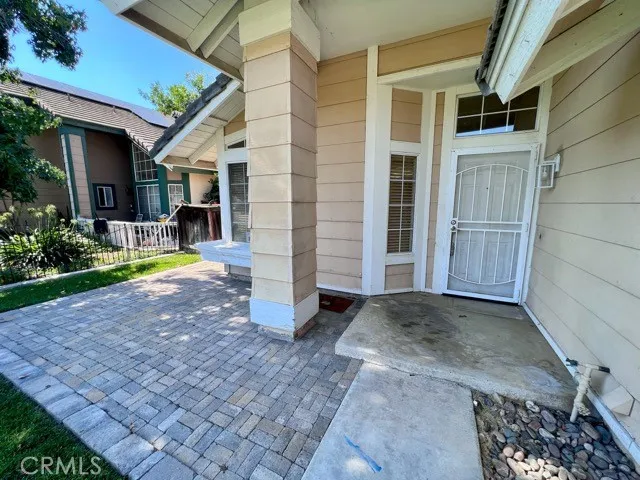 a view of a house with backyard porch and sitting area