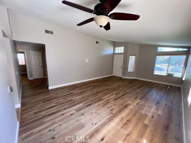 39879 Osprey Road Murrieta, CA 92562 - Photo 7 of 38 a view of an empty room with window and wooden floor