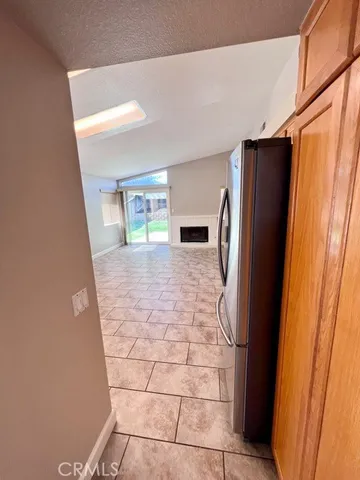 a view of a refrigerator in kitchen and entryway