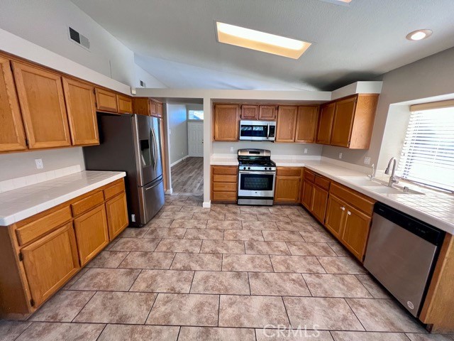 39879 Osprey Road Murrieta, CA 92562 - Photo 9 of 38 a kitchen with stainless steel appliances a refrigerator sink and microwave
