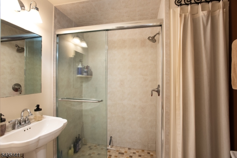 14 Locust Street Madison, NJ 07940 - Photo 11 of 33 a bathroom with a shower and a sink