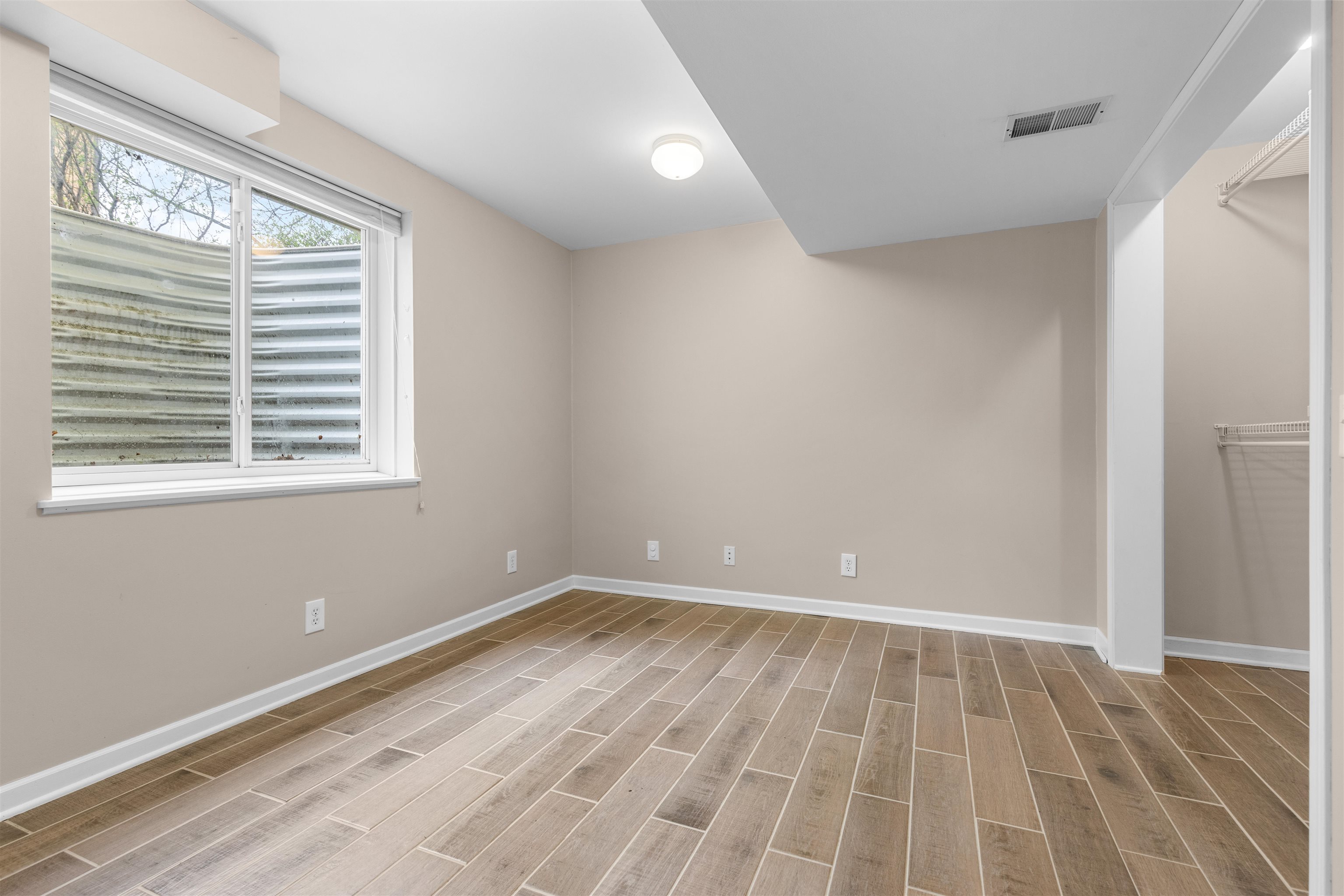 607 South 6th Street Oregon, IL 61061 - Photo 19 of 23 a view of an empty room with wooden floor and a window